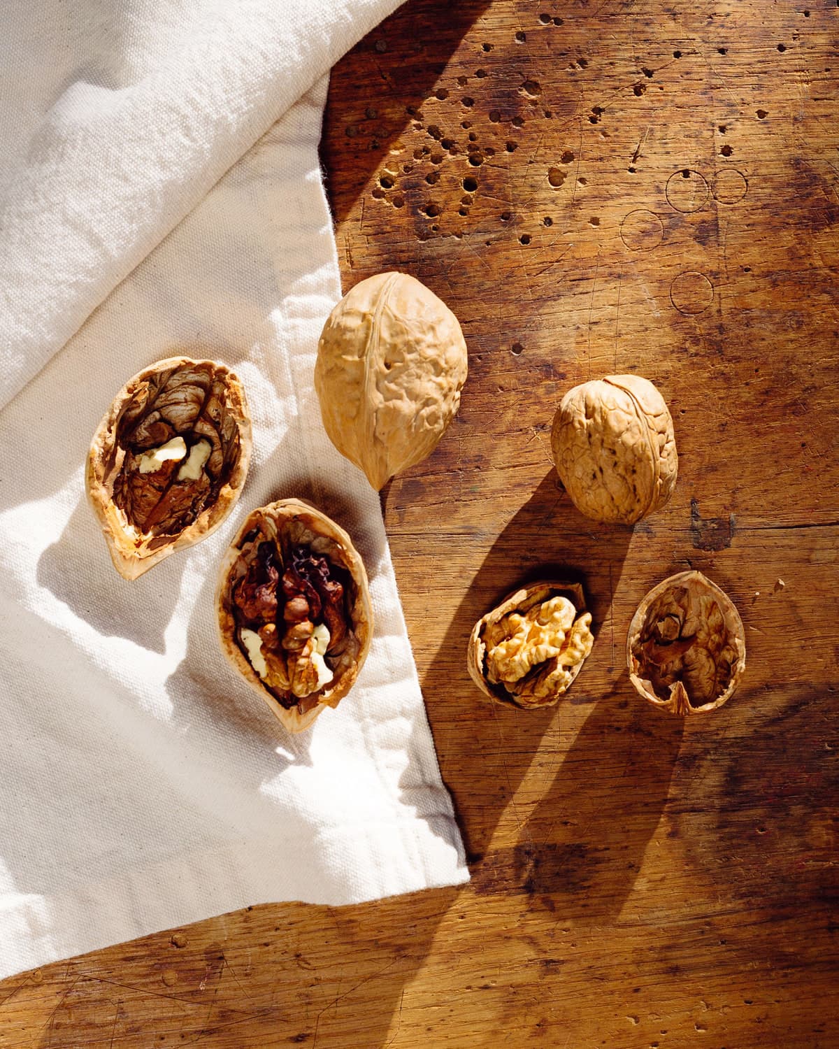 BM Chabi walnuts cracked open on a wooden board