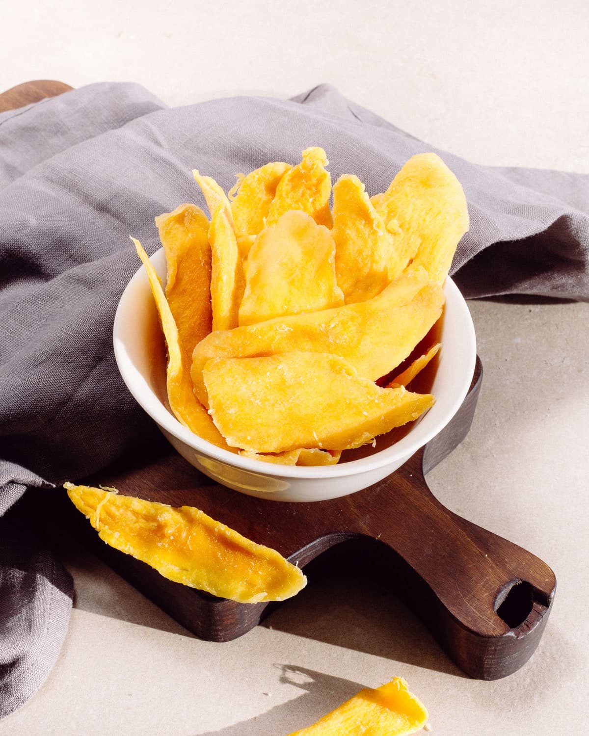 BM dried mango slices in a white bowl