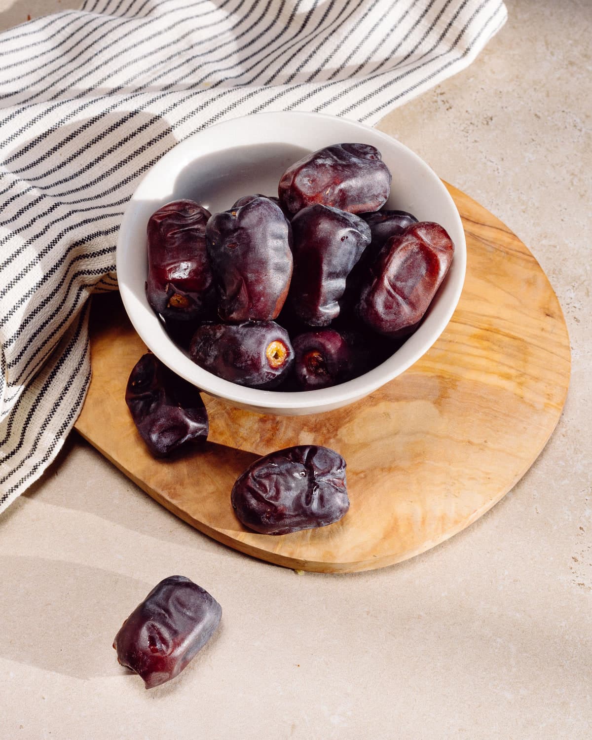 Very dark BM Kali dates in a white bowl