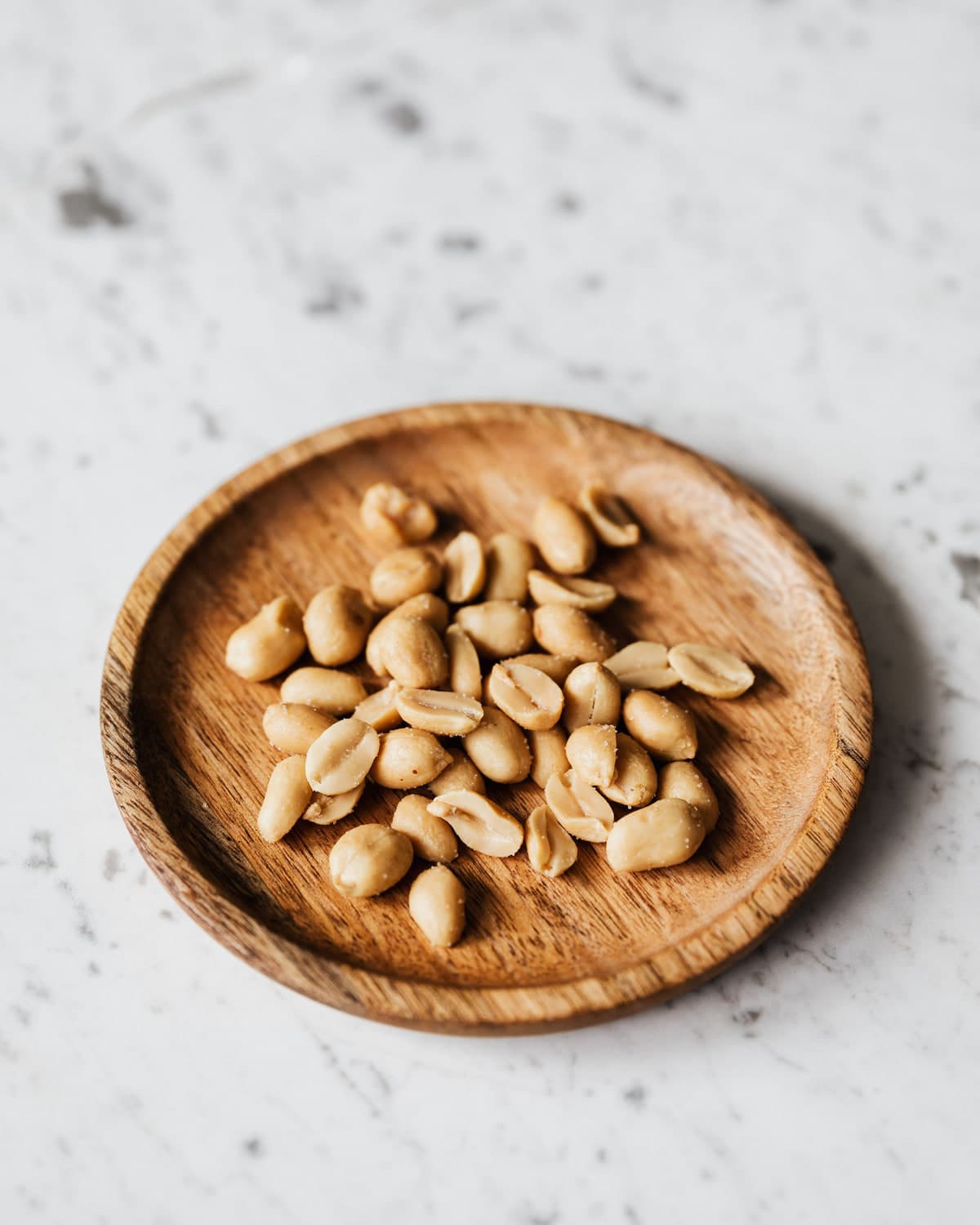 BM peanut kernels in a wooden dish