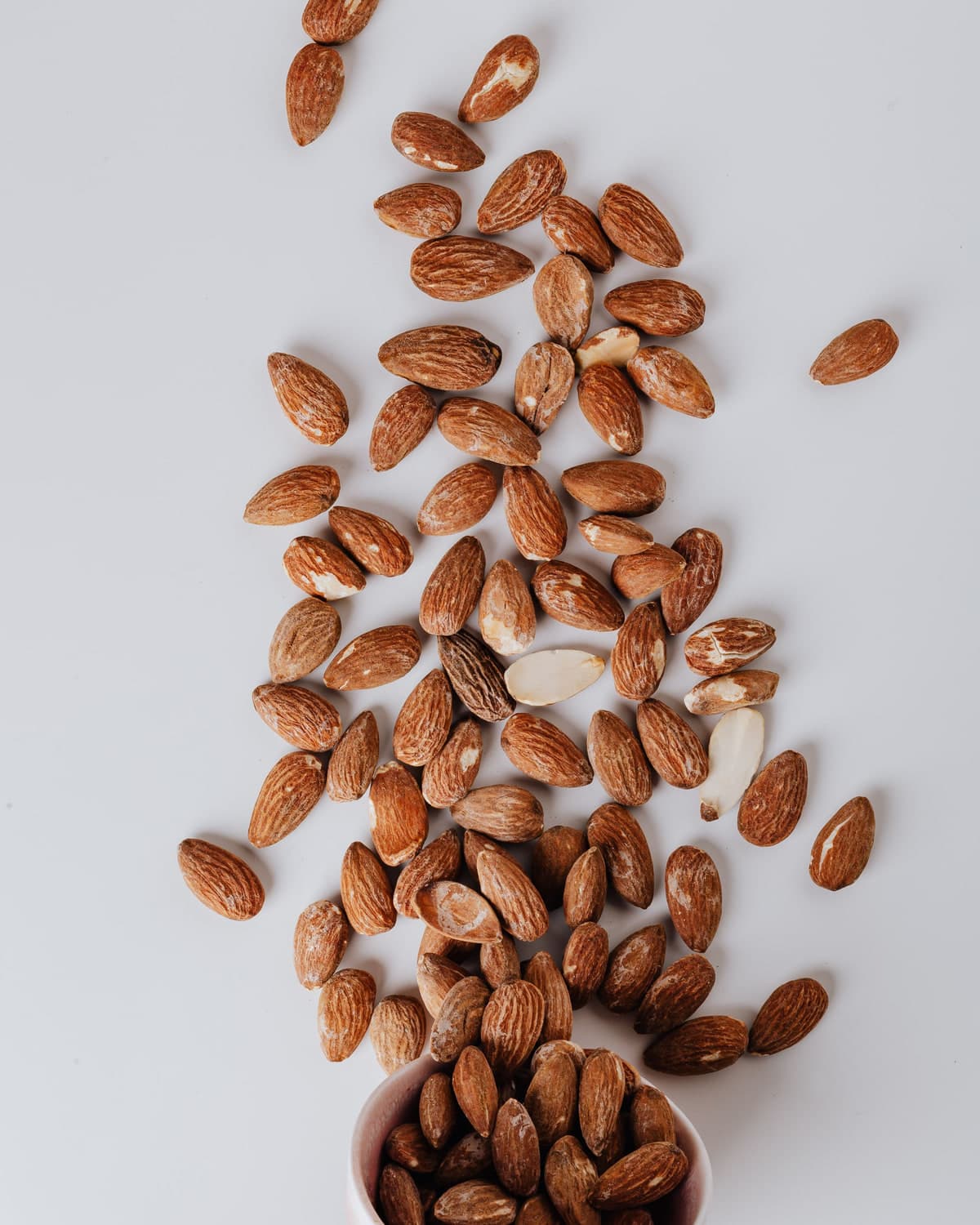 BM Seyara almonds scattered on a pale surface